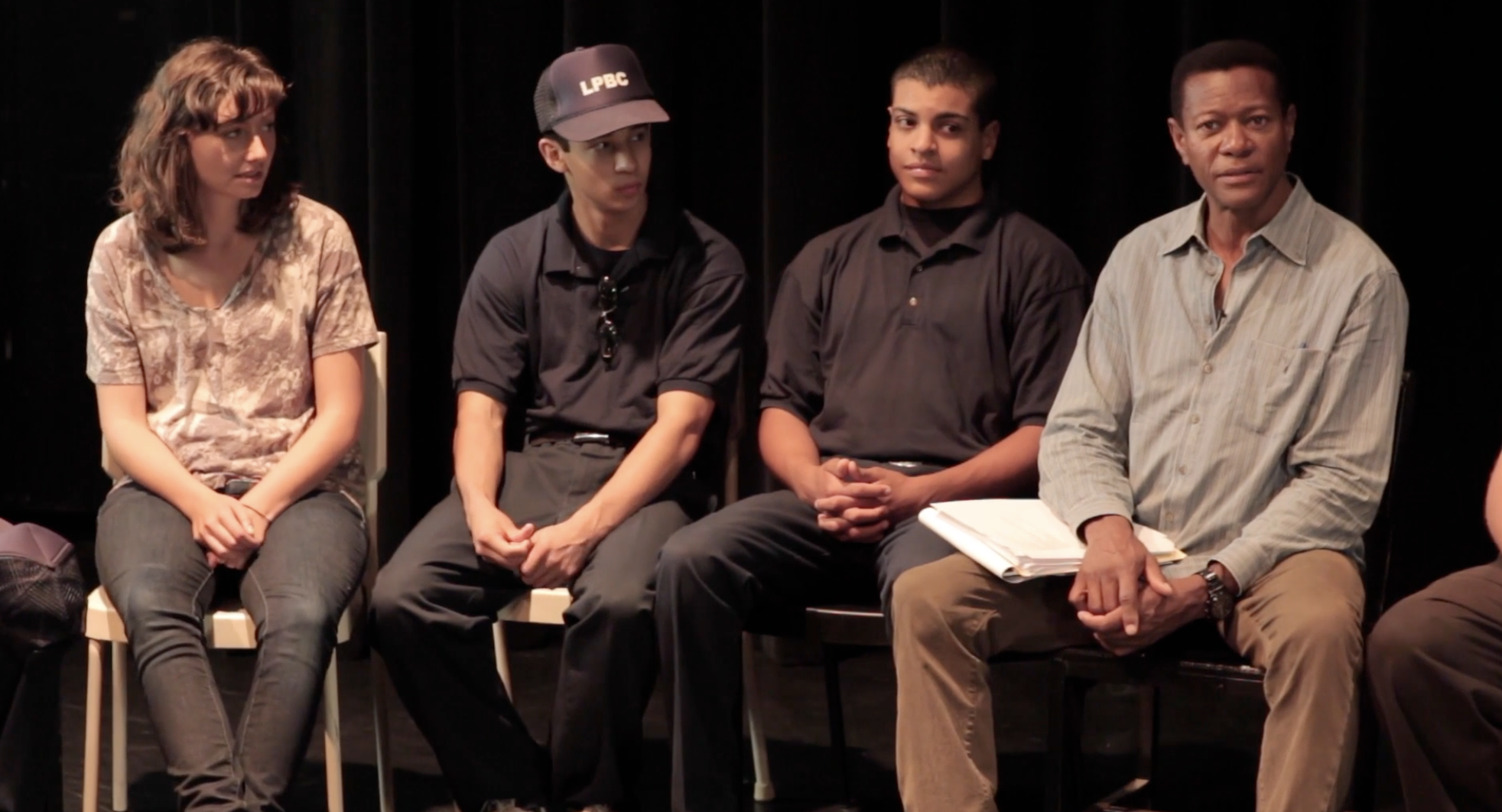 Participants seated in a circle during a community discussion